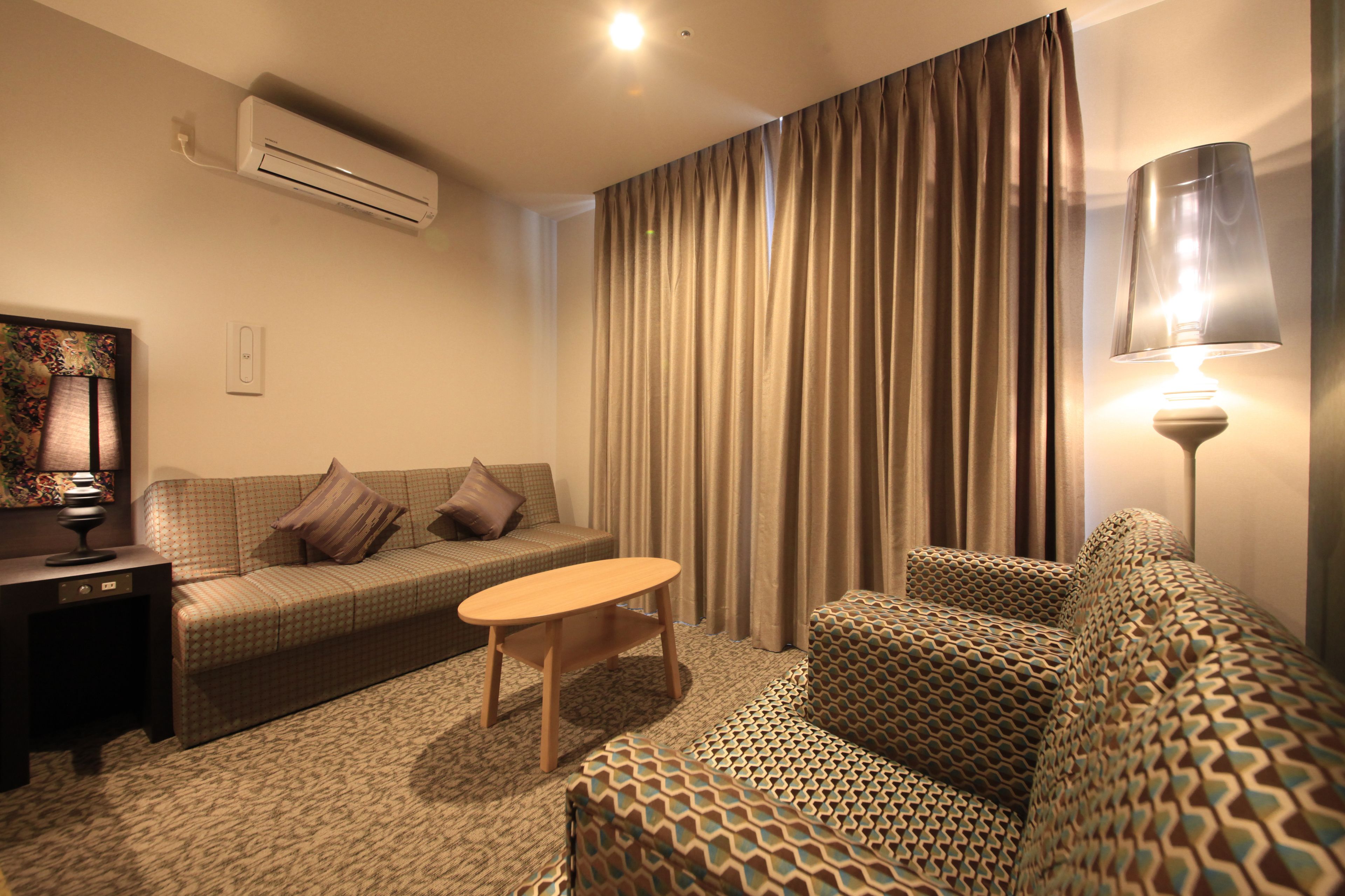 deluxe twin room, non smoking - extra sofa bed is from 5th adult | living area | flat-screen tv