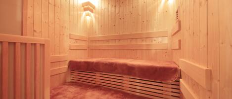 A wooden sauna with a bench and slatted walls.