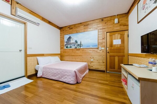 A bedroom with a wooden floor, a bed with a pink quilt, a painting of a castle on the wall, and a wooden door. - Don't Leave Fun (Guanshan)
