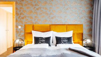 A neatly made bed with two pillows, a headboard, and bedside lamps.