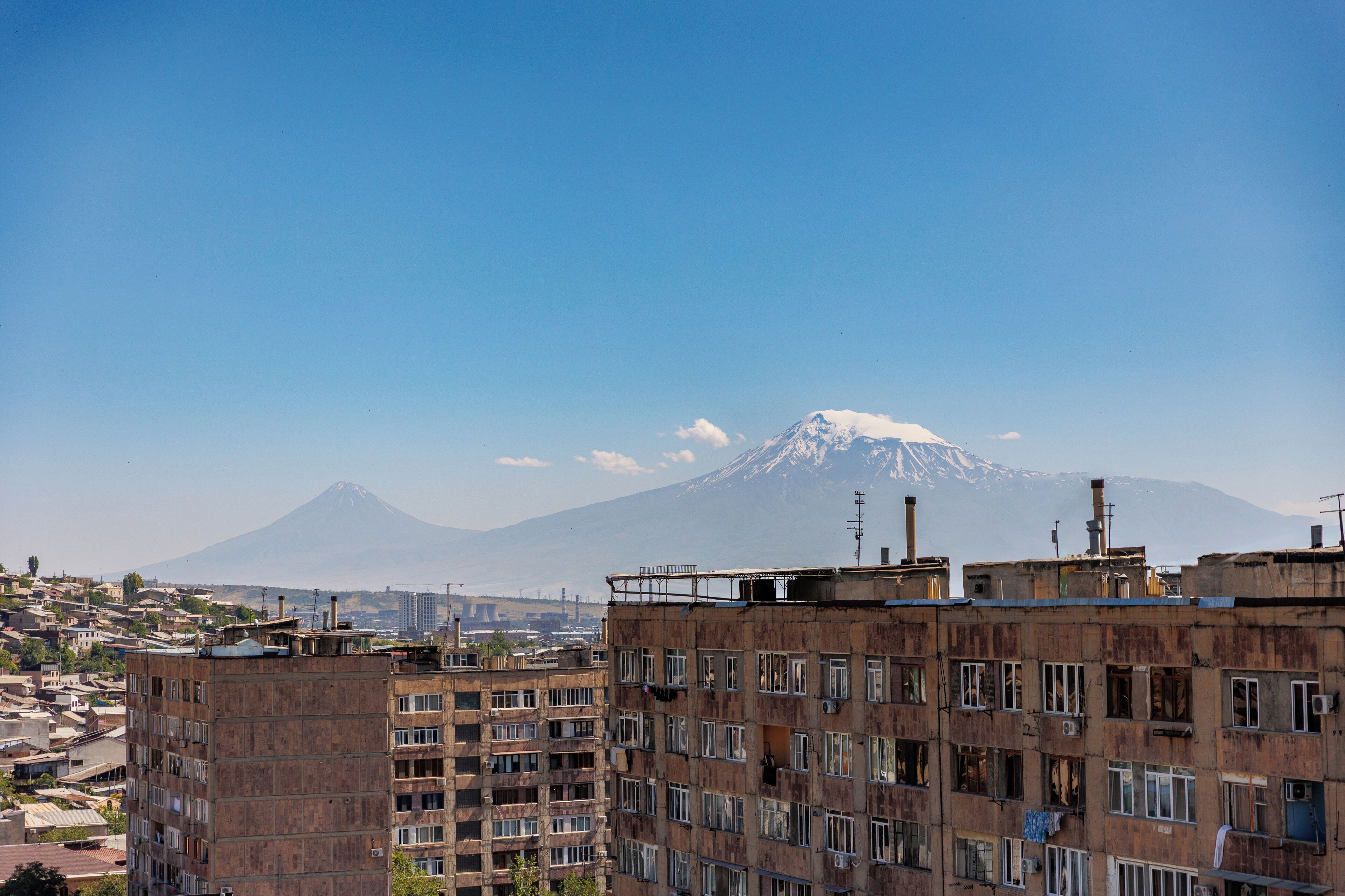 A multi-story building with a view of a mountain in the background.
