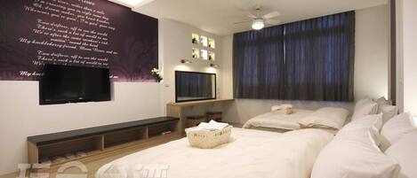 A modern hotel room with two beds, a flat-screen TV, a ceiling fan, and a large window with curtains.