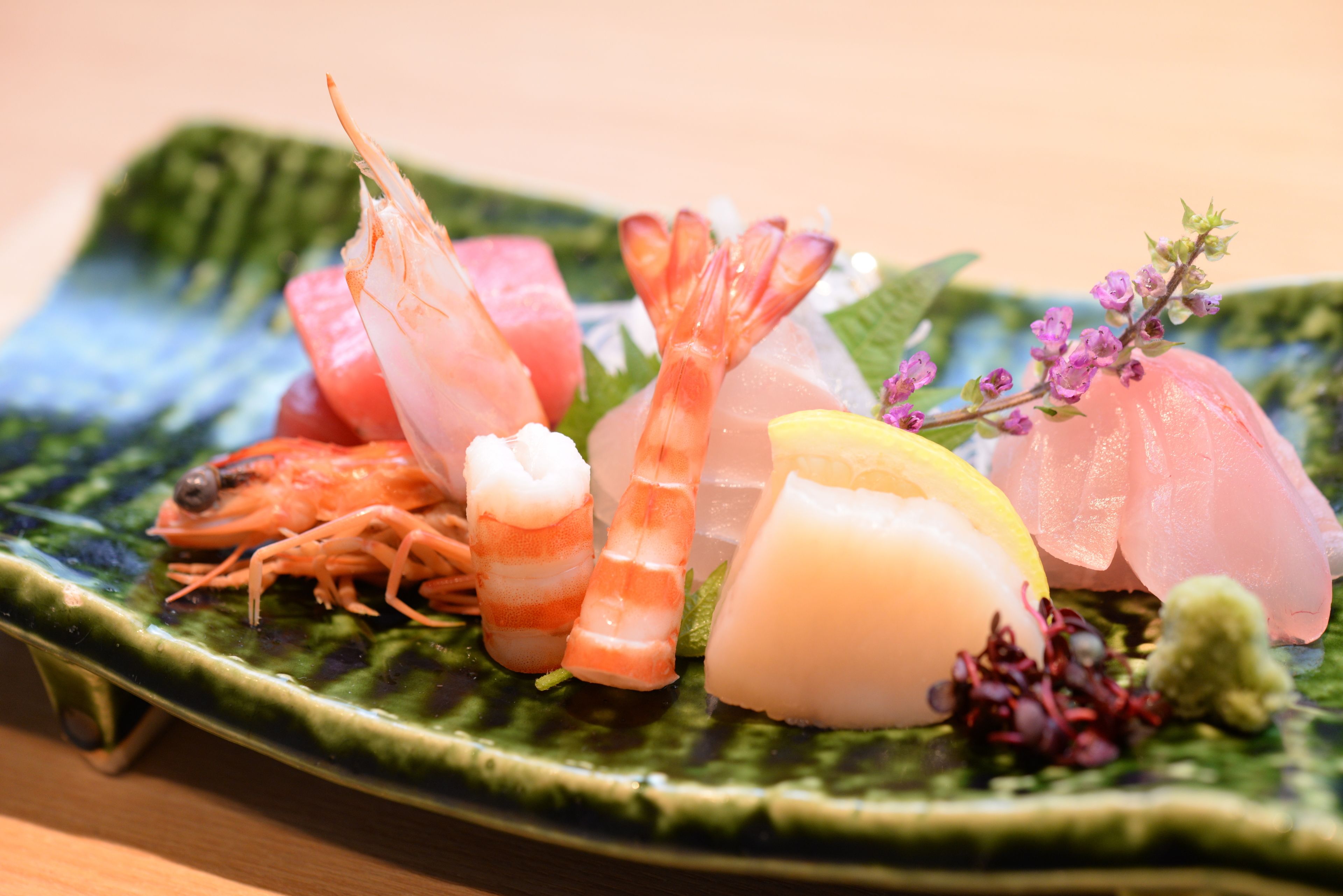 A plate of assorted seafood including shrimp, fish, and squid.