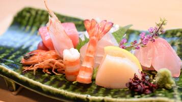 A plate of assorted seafood including shrimp, fish, and squid.