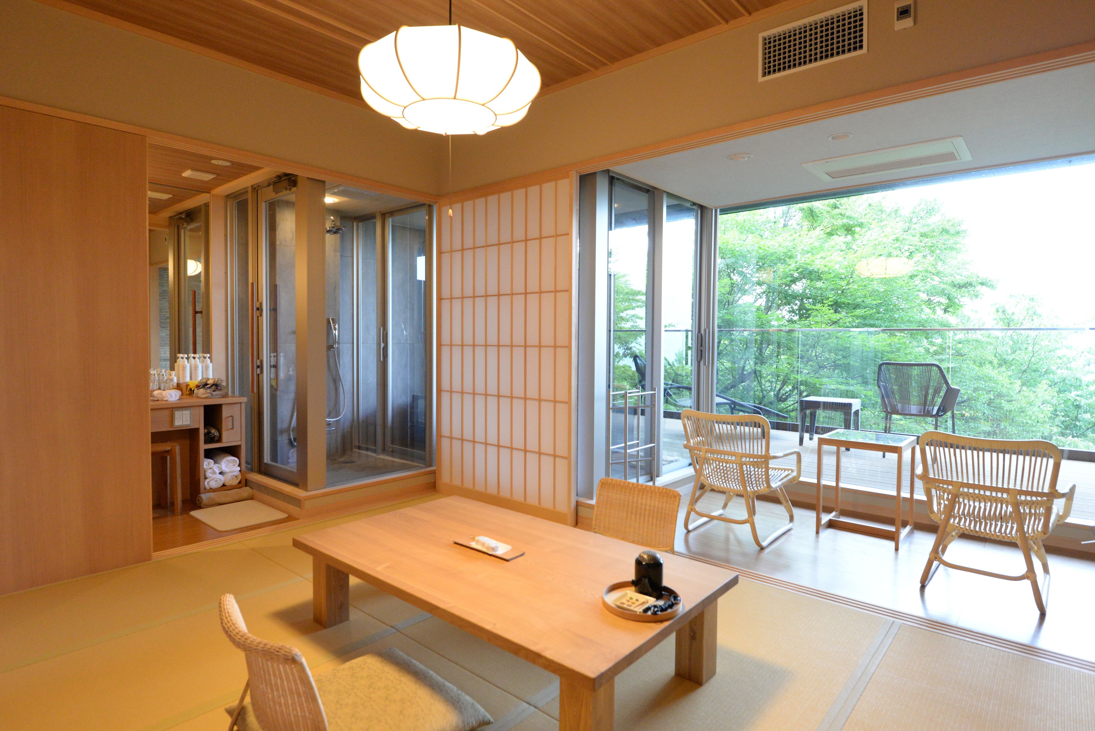 A traditional Japanese-style room with tatami flooring, a low wooden table, and shoji screens.