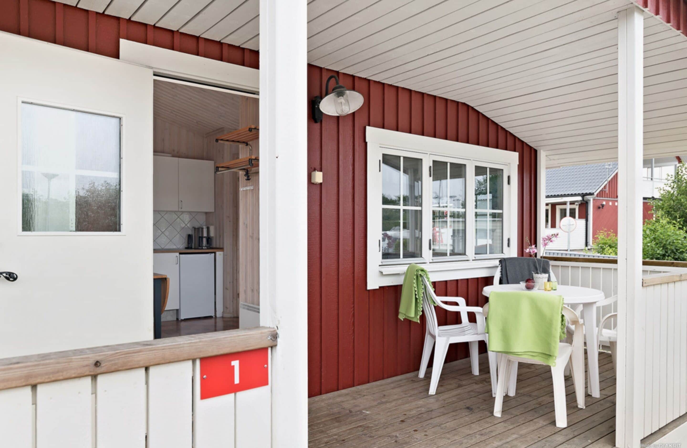 A red exterior with a white door and a small kitchen visible inside.