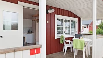 A red exterior with a white door and a small kitchen visible inside.