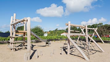 Kids can climb and slide on this beach play structure.