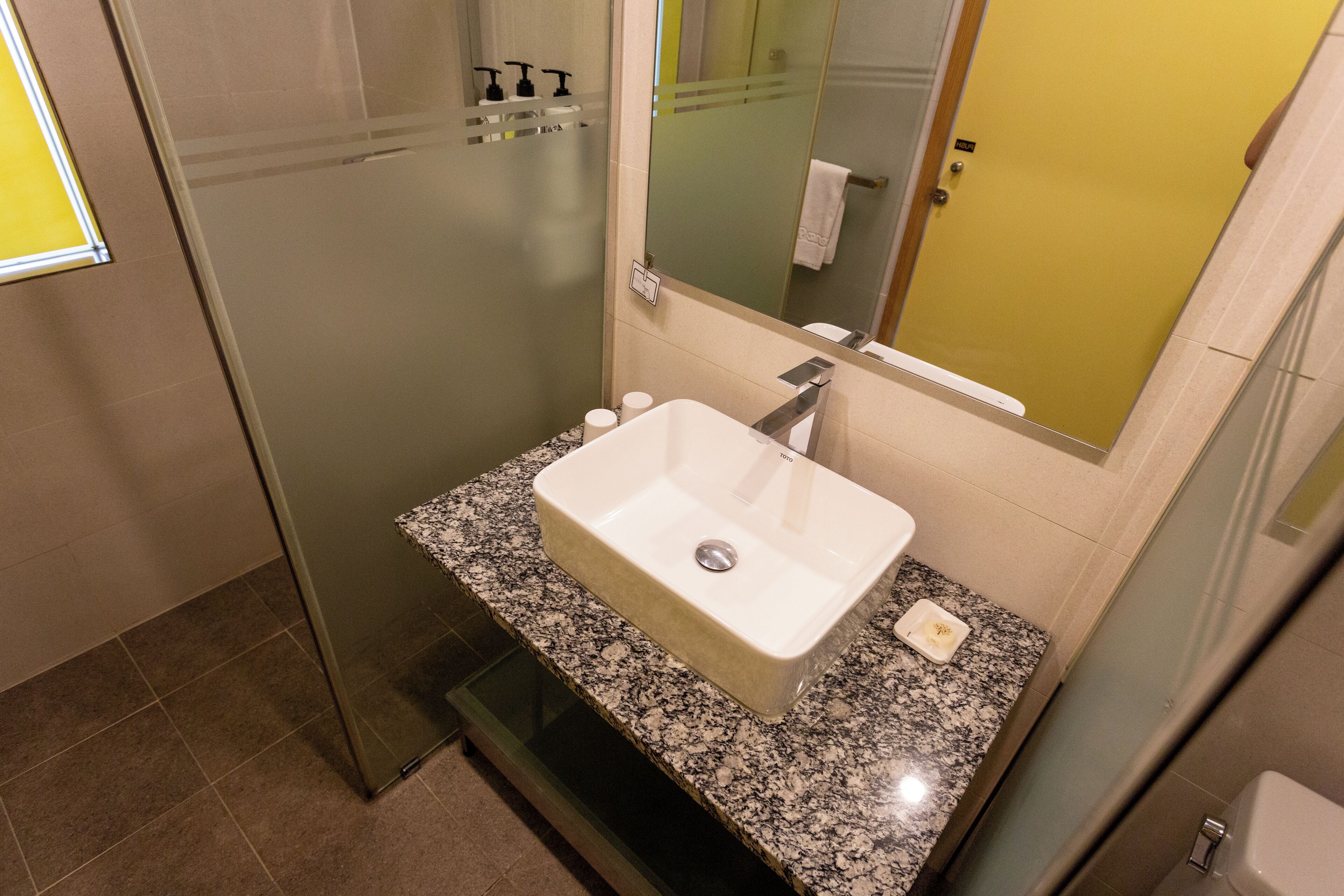 shower, hair dryer, slippers, towels