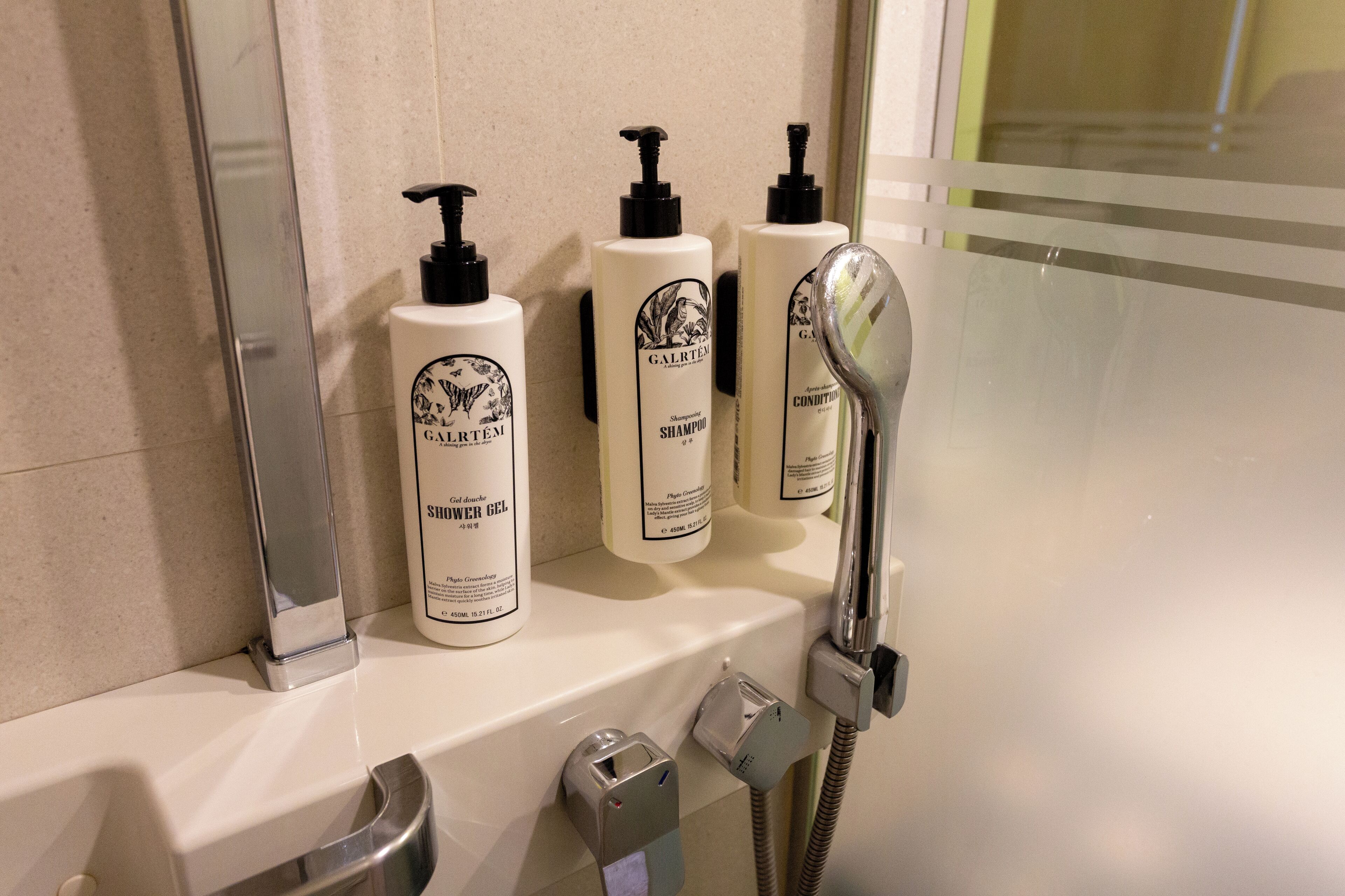 shower, hair dryer, slippers, towels