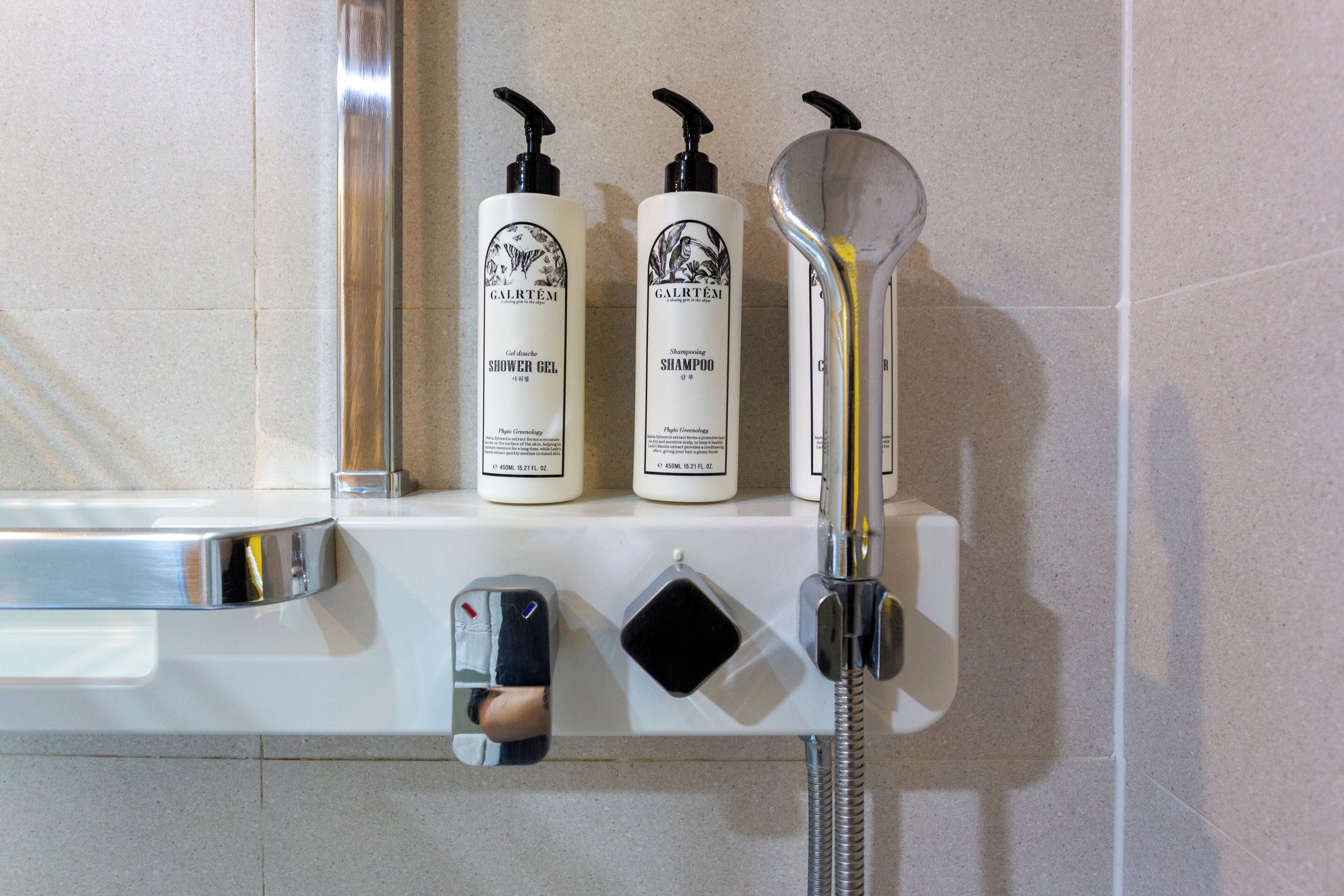 shower, hair dryer, slippers, towels