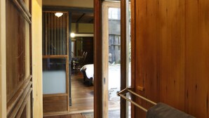 A wooden hallway with a door leading to a room. - Shimoza-an Kamanza-Tei (Kyoto)
