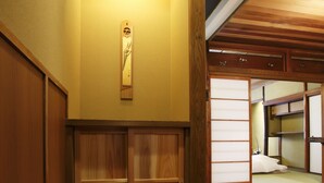 A traditional Japanese room with tatami flooring, sliding doors, and a wooden ceiling. - Miyaki-tei (Kyoto)