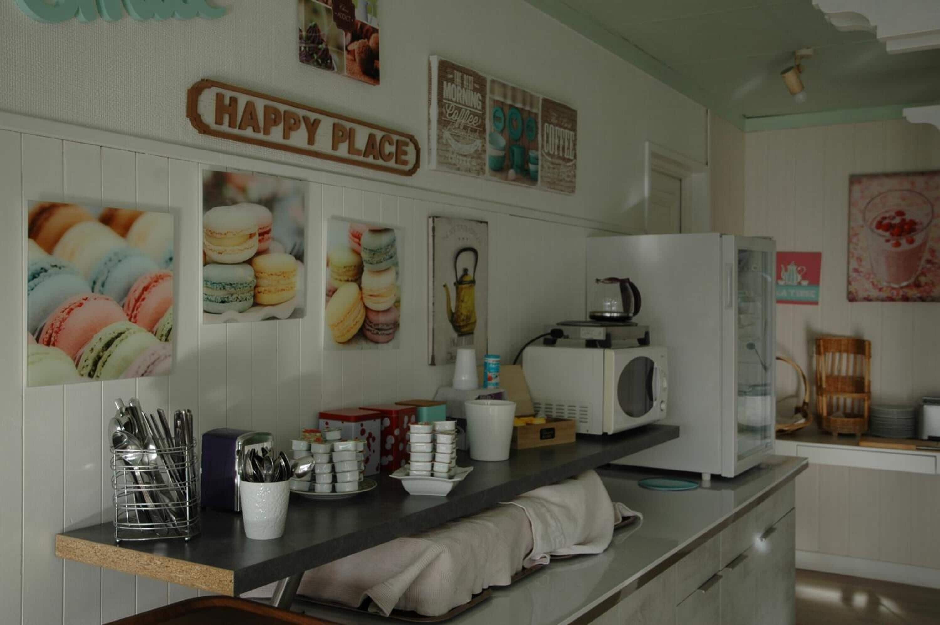 A kitchen counter with a coffee machine, a microwave, and various kitchen items.