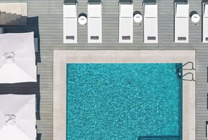 A rooftop pool area with lounge chairs and umbrellas. - Mercure Patras Astir (Patras)