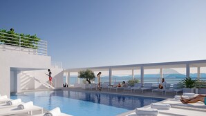 Un área de piscina en la azotea con vista despejada al océano, sillones de descanso y una escalera que lleva a un nivel superior.