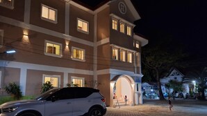 A multi-story building with a car parked in front. - Pagudpud Rinnovati Beach Resort (Pagudpud)