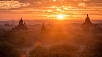 A sunset view of a temple complex with multiple structures.