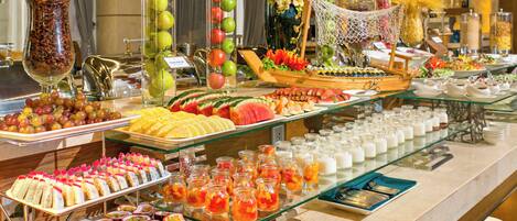 A buffet with various food items and beverages.