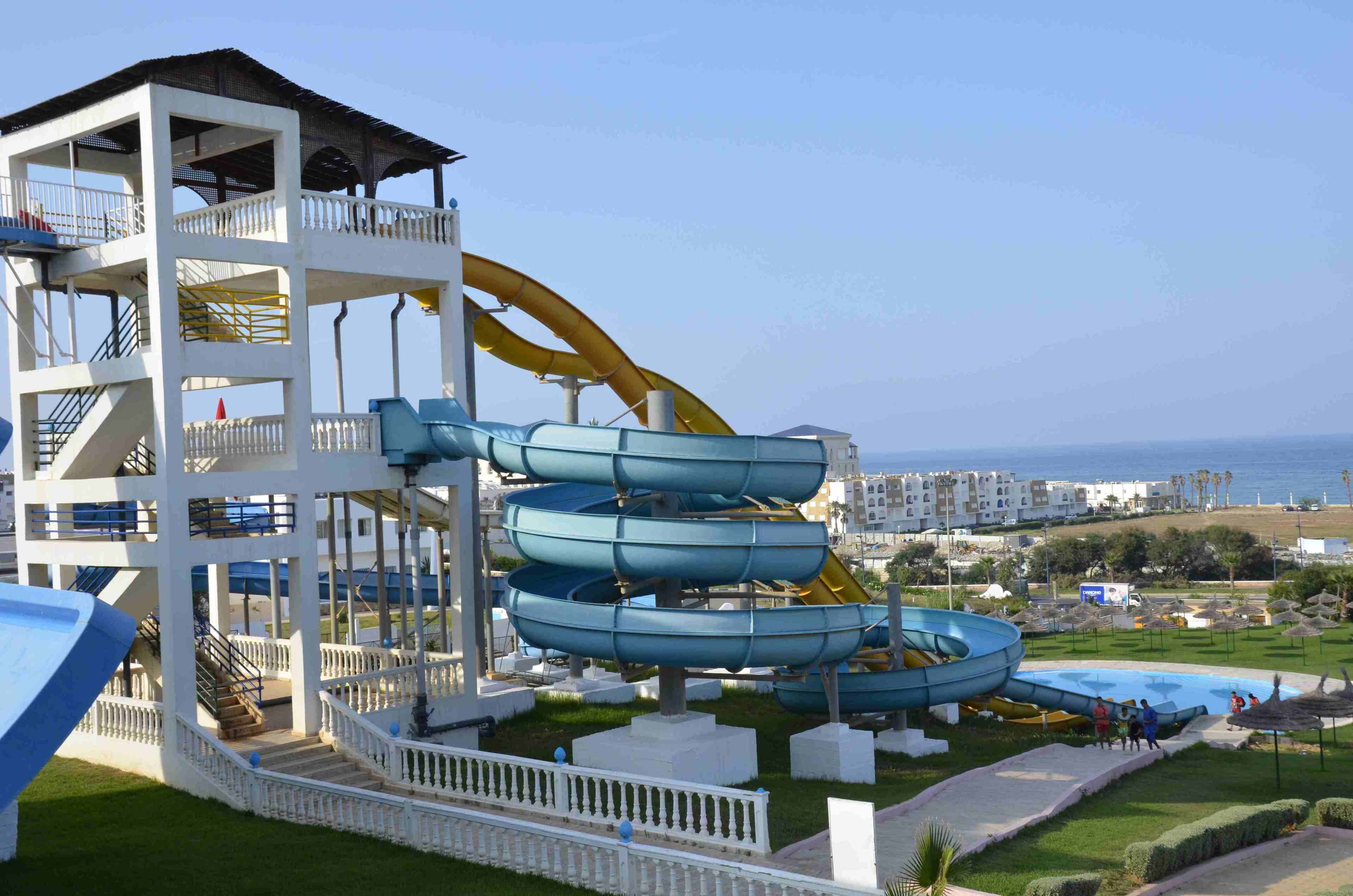 A water park with multiple slides and a pool area.