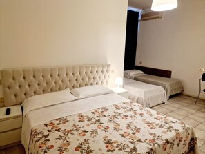 Habitación cuádruple | Escritorio, tabla de planchar con plancha, camas supletorias gratuitas