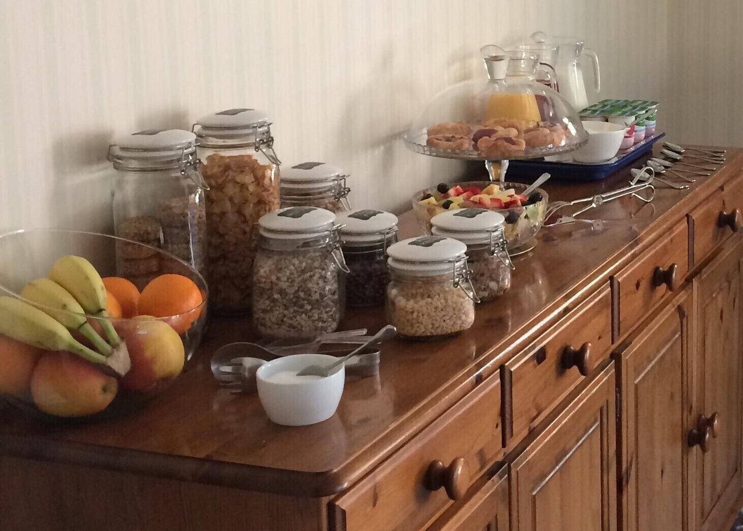 A breakfast buffet with various food items and condiments.