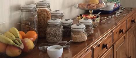 A breakfast buffet with various food items and condiments.