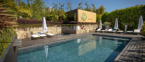 Indoor pool, seasonal outdoor pool, pool umbrellas, pool loungers