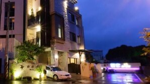 A modern two-story building with a car parked in front. - Puli Waltz Villa (Puli)