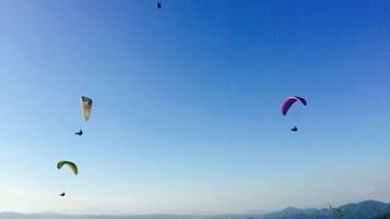 A clear sky with multiple parachutes in various colors.