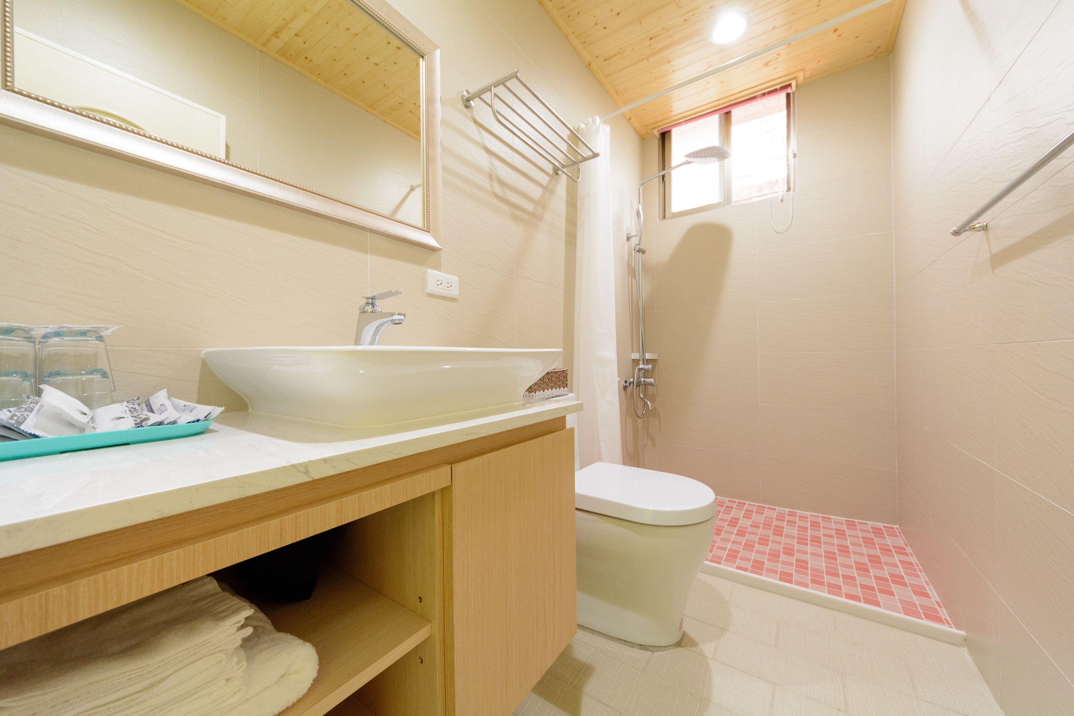 A bathroom with a sink, mirror, and toilet.