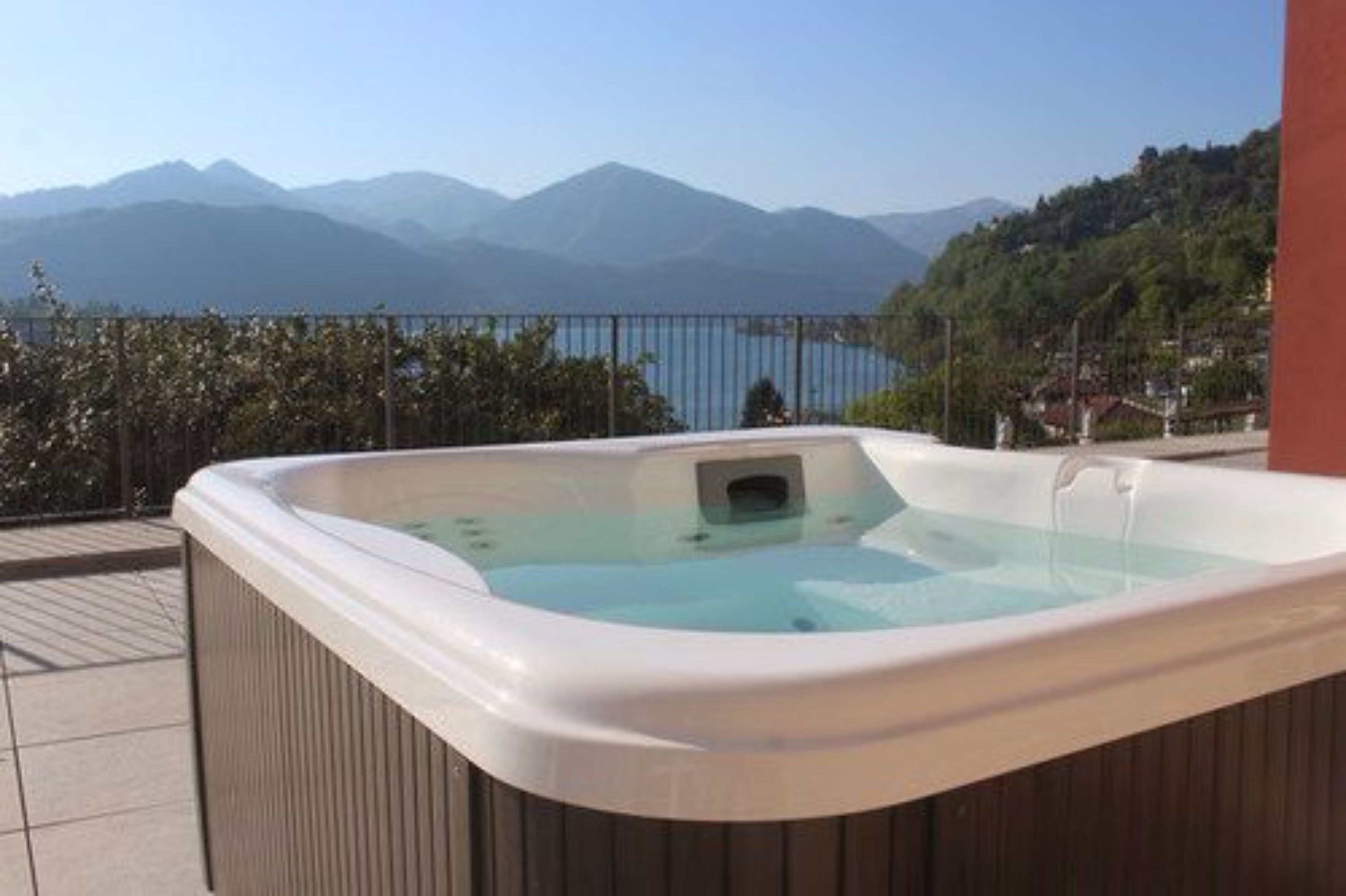 A hot tub on a balcony with a mountain view.