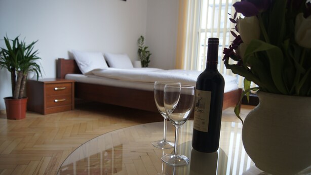 Une chambre à coucher avec un lit, une table de chevet et une plante en pot.