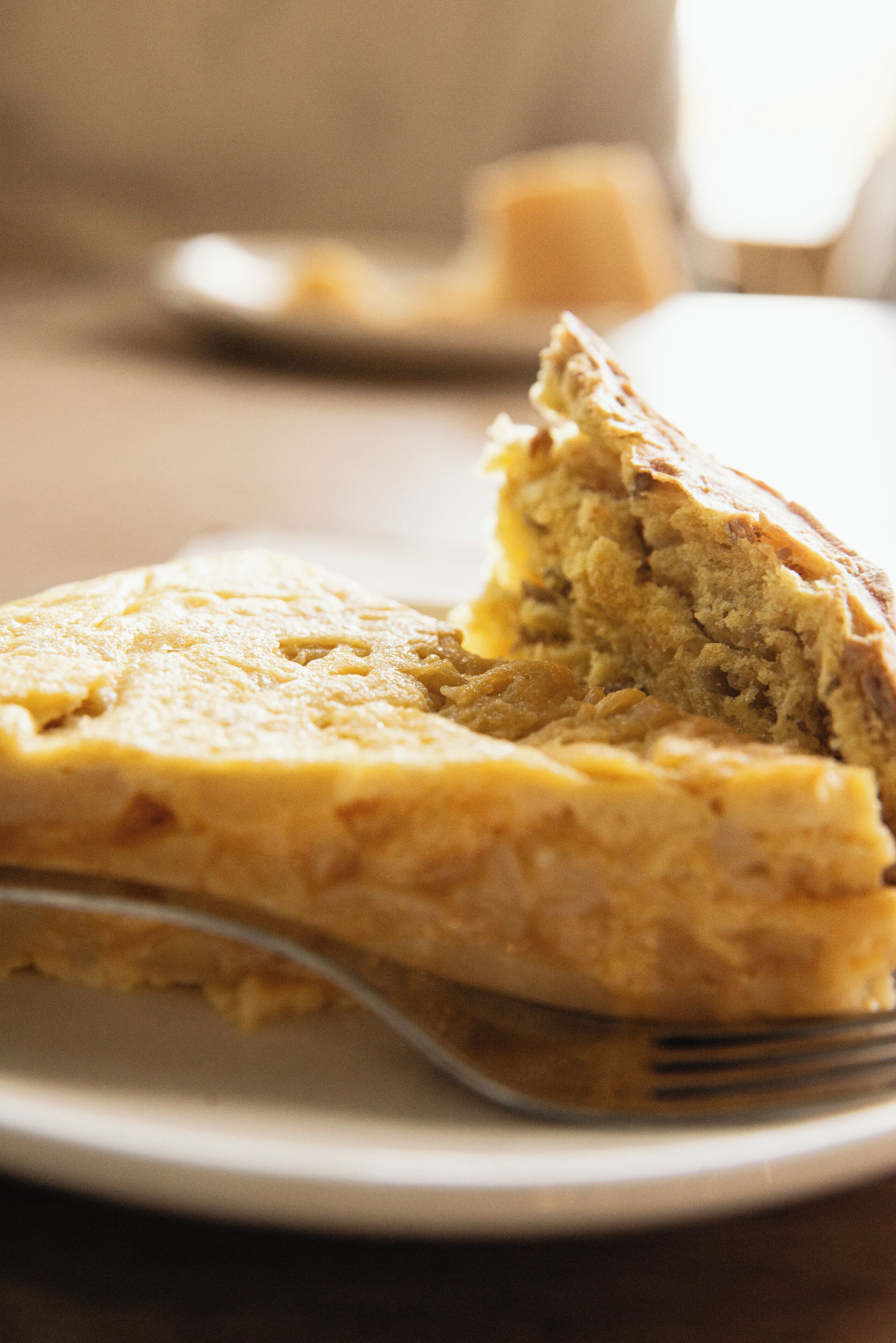 A slice of cake on a plate with a fork.