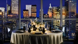A table set for dining with a city skyline view in the background. - Bisha, a Luxury Collection Hotel Toronto (Toronto)