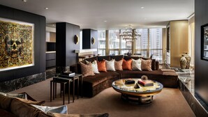 A modern living room with a sectional sofa, a round coffee table, and a large abstract painting. - Bisha, a Luxury Collection Hotel Toronto (Toronto)