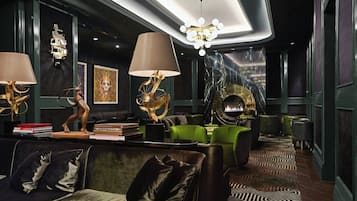 A modern interior with a fireplace, seating area, and decorative lamps.