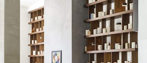 Un salon moderne doté d’une cheminée, d’une grande bibliothèque et d’un espace détente avec un canapé et des fauteuils.