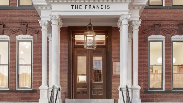 A brick building with a grand entrance labeled "THE FRANCIS." - The Francis (Portland)