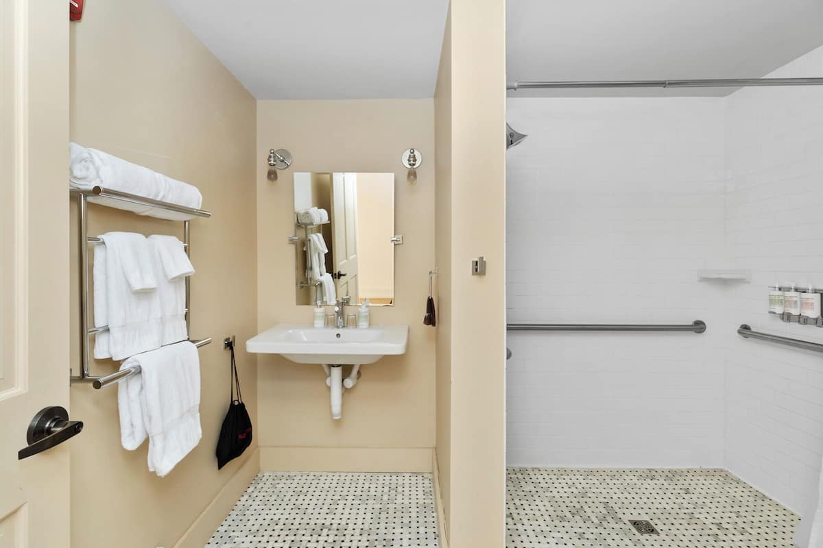 signature room, 1 king bed, accessible | bathroom | shower, free toiletries, hair dryer, bathrobes