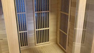 A sauna with wooden slats and a caution sign on the wall.