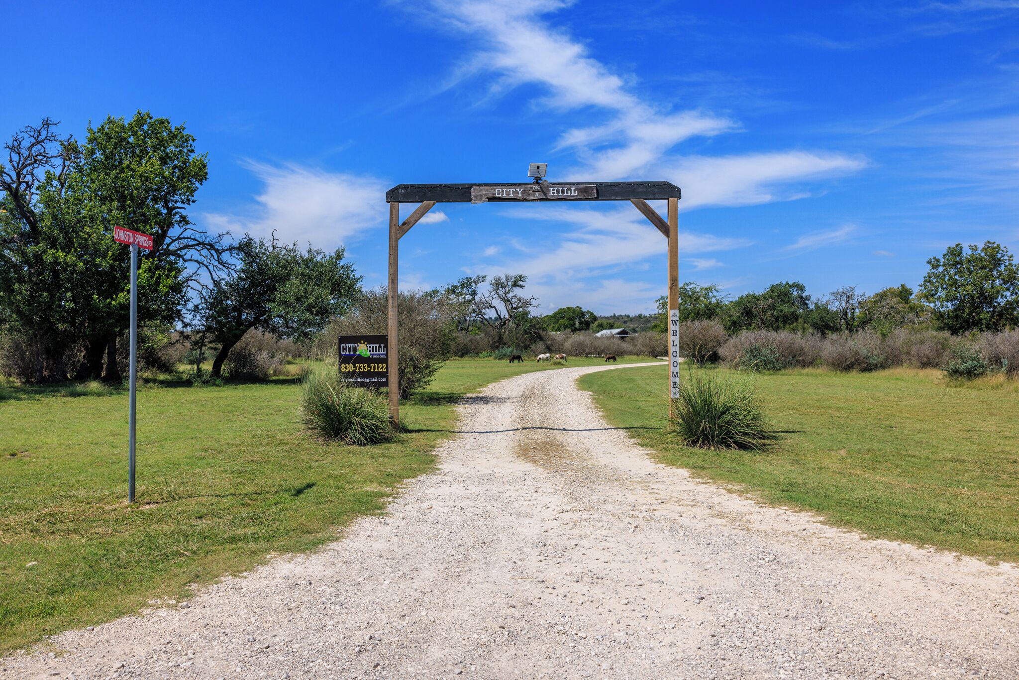 A rural road leading to a property named "City Hill."