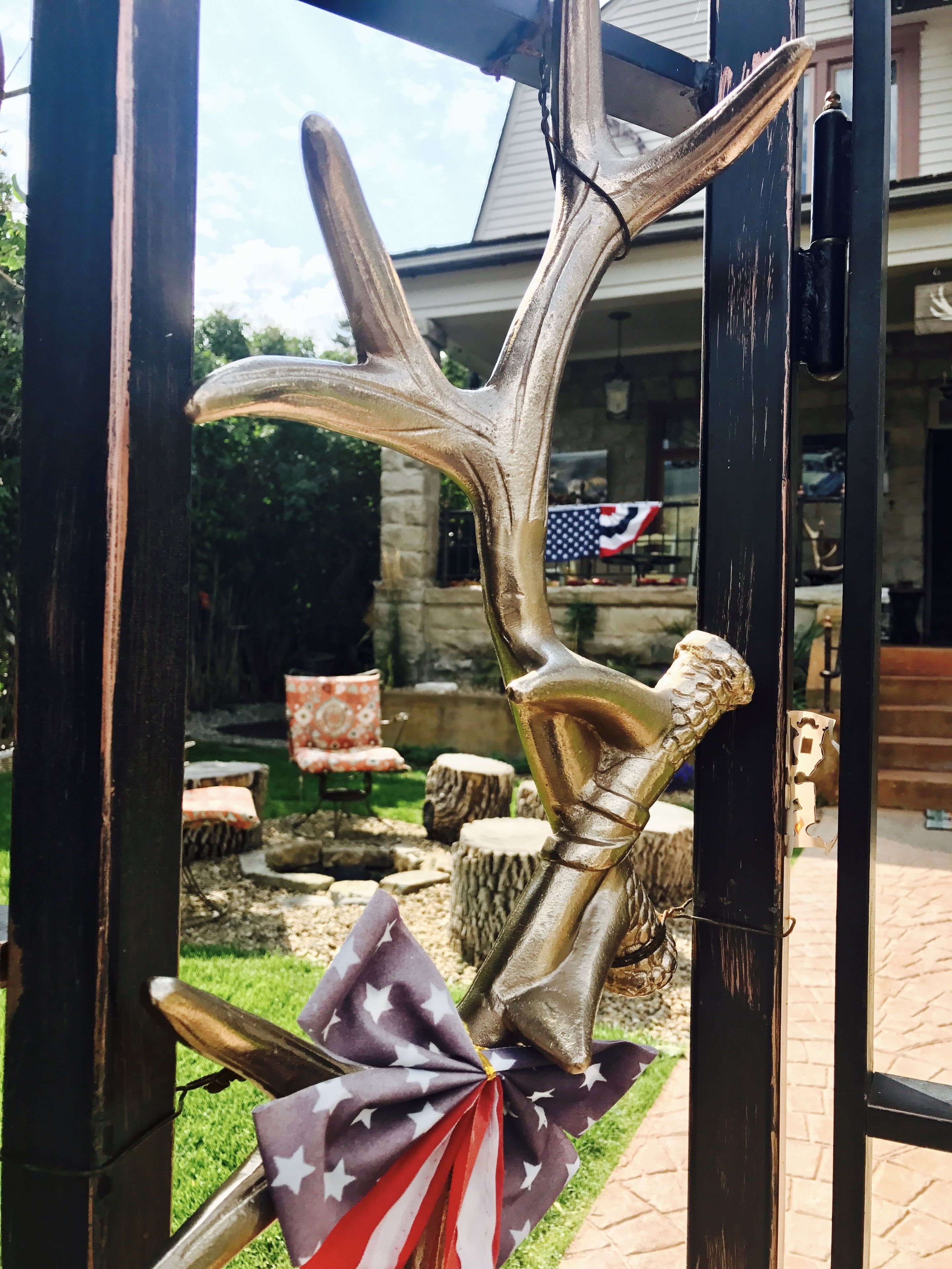 A decorative metal sculpture with antlers and an American flag.