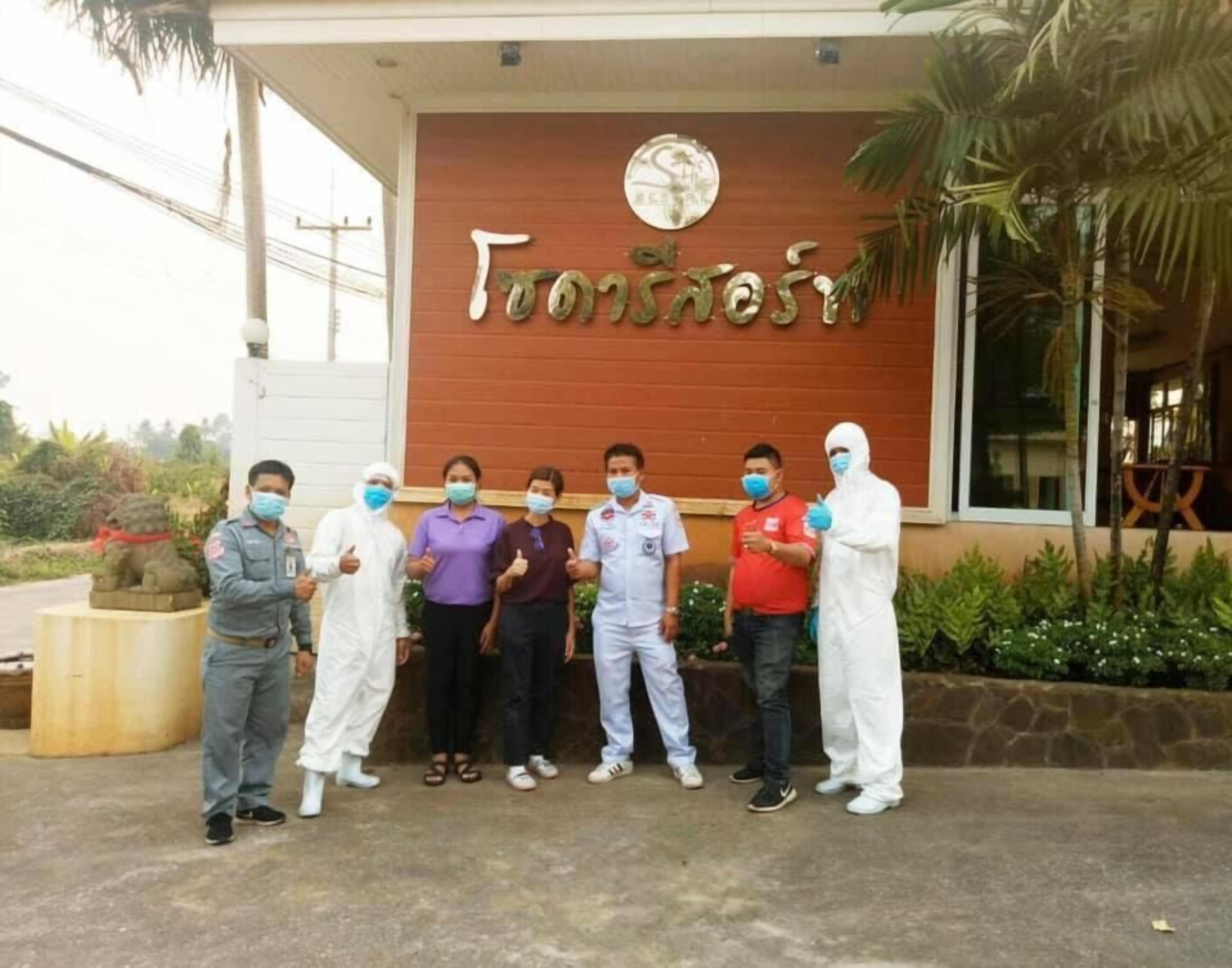 A group of people standing in front of a building with a sign that reads "Frontera."
