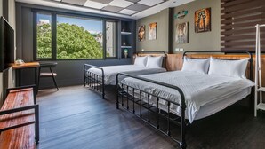 A modern hotel room with two beds, a desk, and a large window offering a city view. - So Funny (Hualien City)