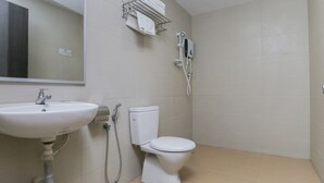A small, clean bathroom with a sink, toilet, and a towel rack. - OYO 89915 East Mount Hotel (Kukup)