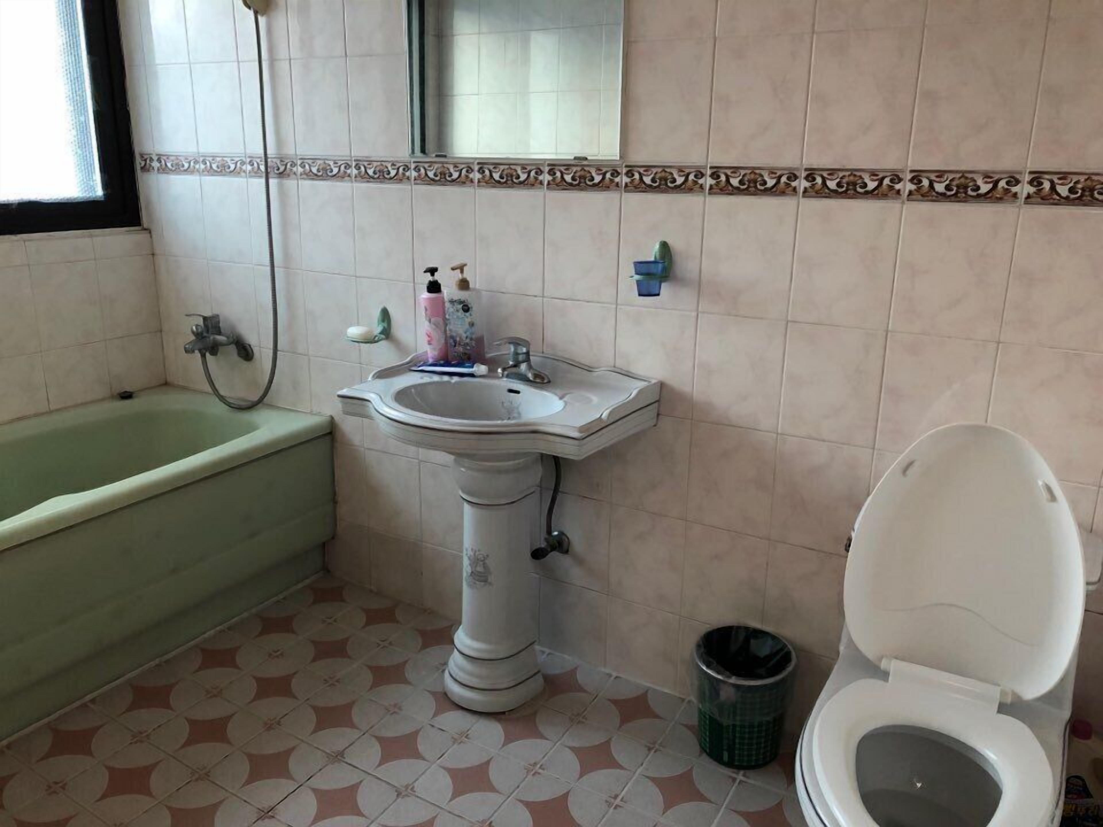 A bathroom with a bathtub, sink, and toilet.