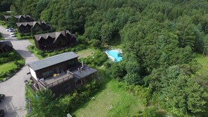 A resort with multiple cabins, a swimming pool, and a lush forested area. - Chalet Resort (Pyeongchang)