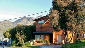 A wooden house with a sloped roof, a front porch, and a garage. - Freycinet Sands (Coles Bay)
