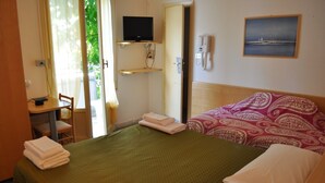 A hotel room with a bed, a desk with a chair, a TV on a shelf, a telephone, and a painting on the wall. - Hotel Nancy (Rimini)